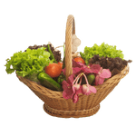 Wicker basket filled with fresh vegetables and pink flowers on a black background